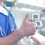 Doctor showing OK sign near the patient in the hospital
